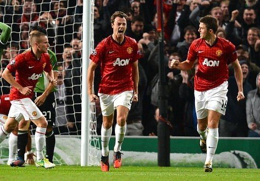 Manchester United's Jonny Evans (C) celebrates with Michael Carrick (R) after scoring